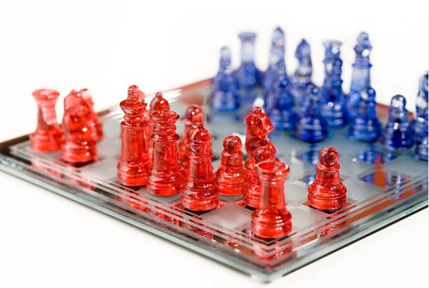 A chess board with red and blue pieces representing red and blue teams